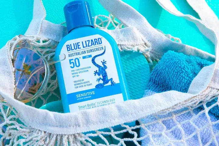Image of Blue Lizard SPF 50 mineral sunscreen bottle in a beach bag, representing Australian mineral sunscreen and family sun protection products