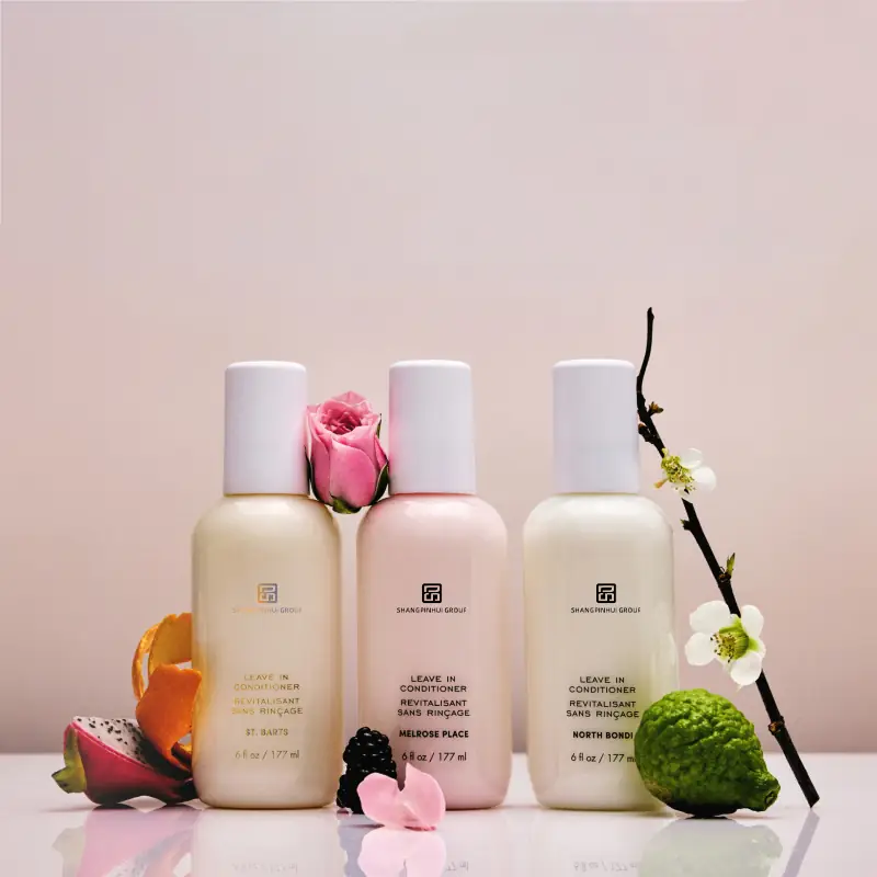 Three private label leave-in conditioner spray bottles with custom fragrance variants