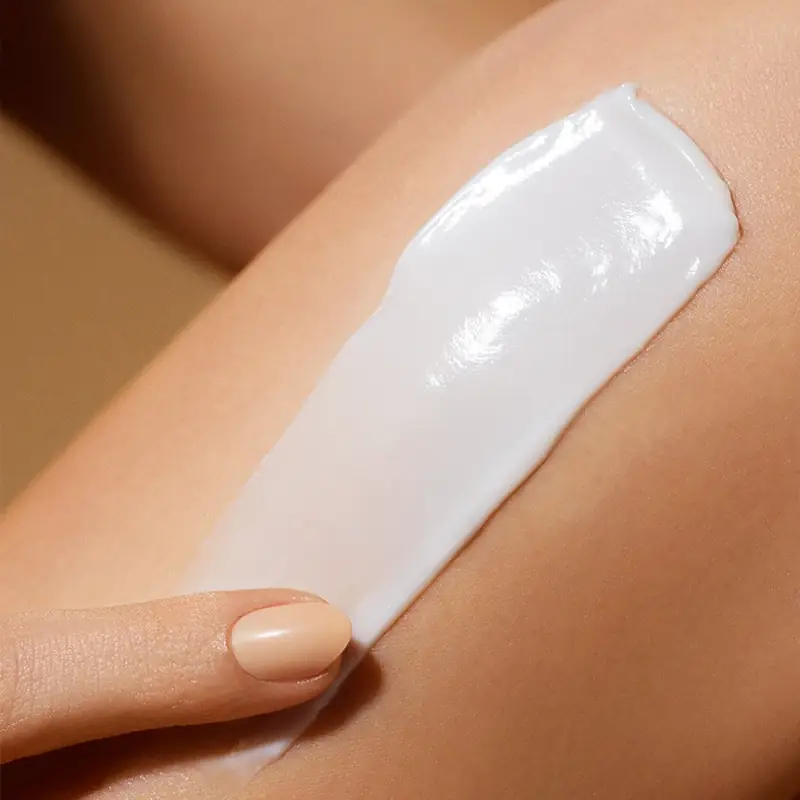 Firming body lotion creamy texture applied on body skin for moisturized smooth skin feel
